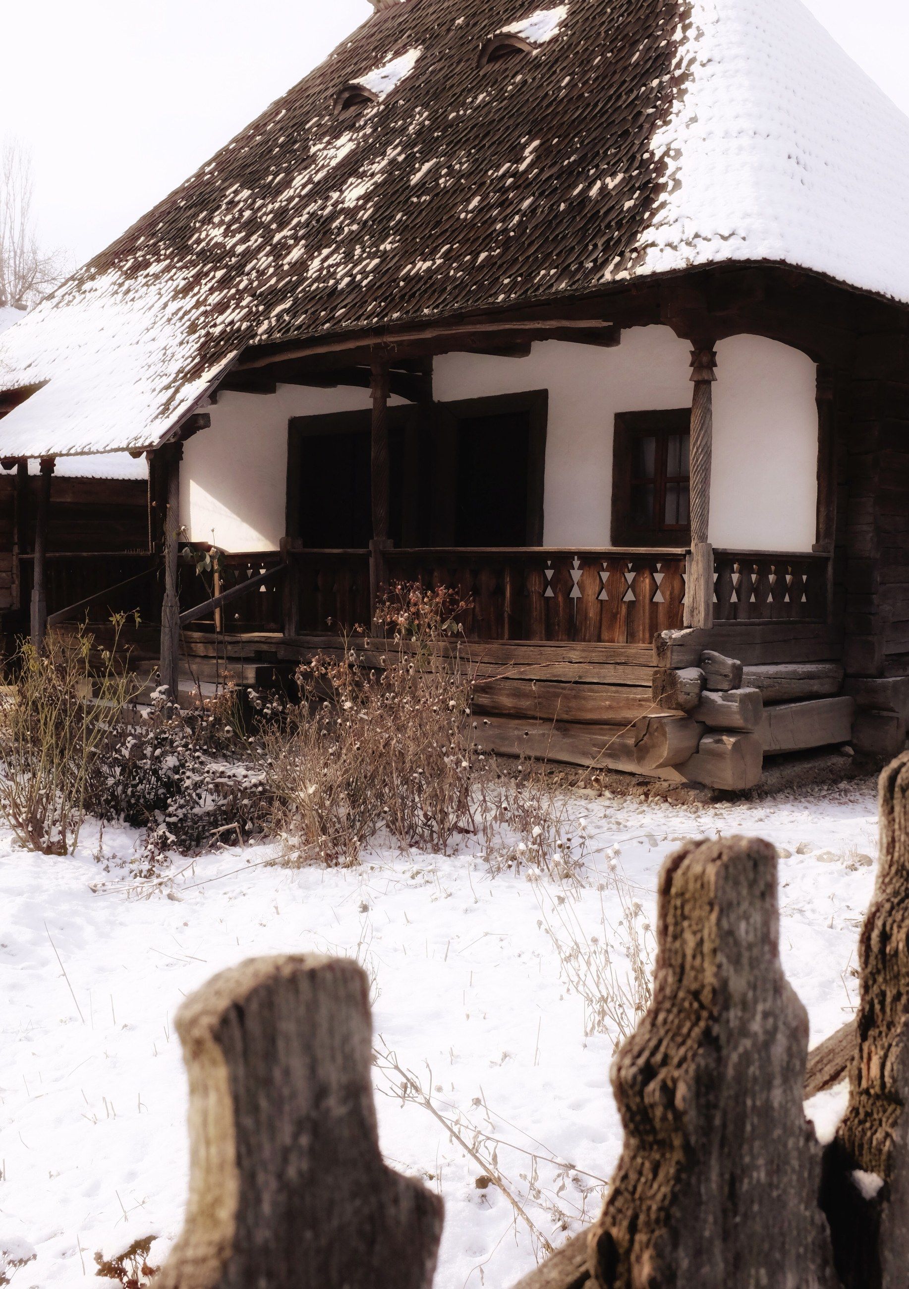 A traditional wooden house in snow